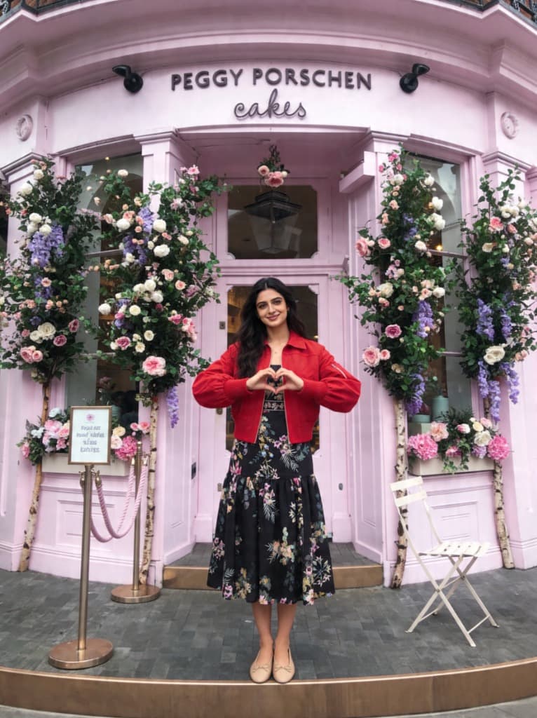 Maya standing in front of Peggy Porschen Cakes in London